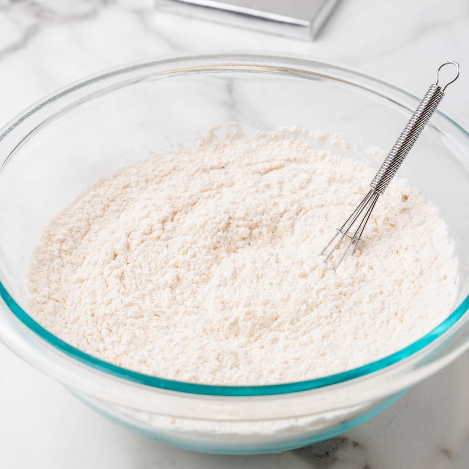 flour in a bowl, stirred with a whisk.