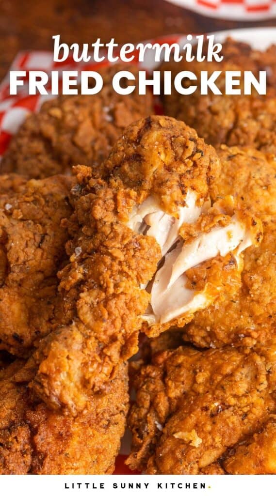 Crispy fried chicken drumstick showing the white meat on the inside to show doneness, and overlay text that says 